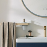 product lifestyle image of vado cameo muse satin brass 450mm towel bar shelf frame with hanging stripy towel with soap dispenser insert MUS-184-45-SBR